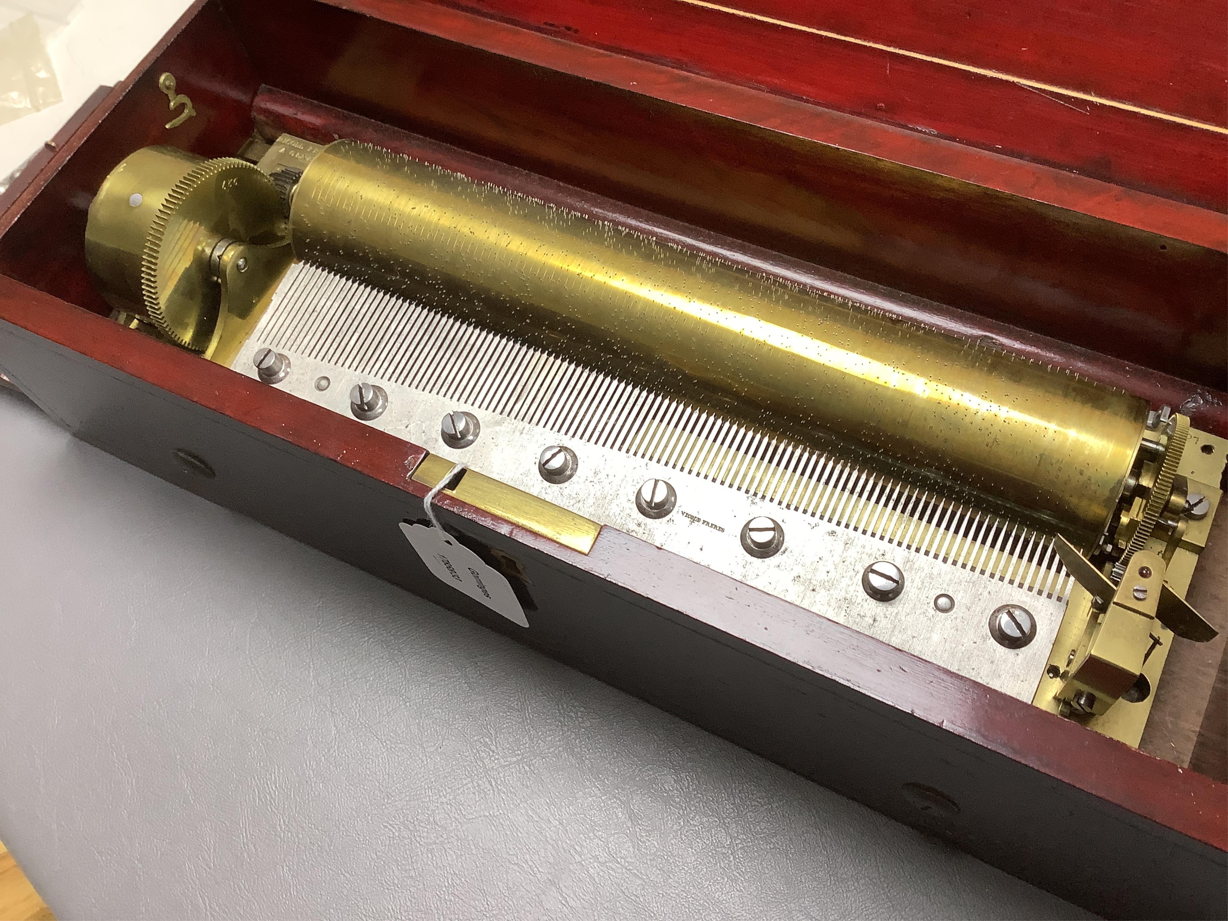 A mid 19th century Nicole Freres key wound cylinder musical box in an inlaid rosewood case, playing on approx 105 tooth comb, cylinder 27.5cm long, stamped ‘Nicole Frere a Geneve’, 26927, with key, the case; 45.5cm wide,